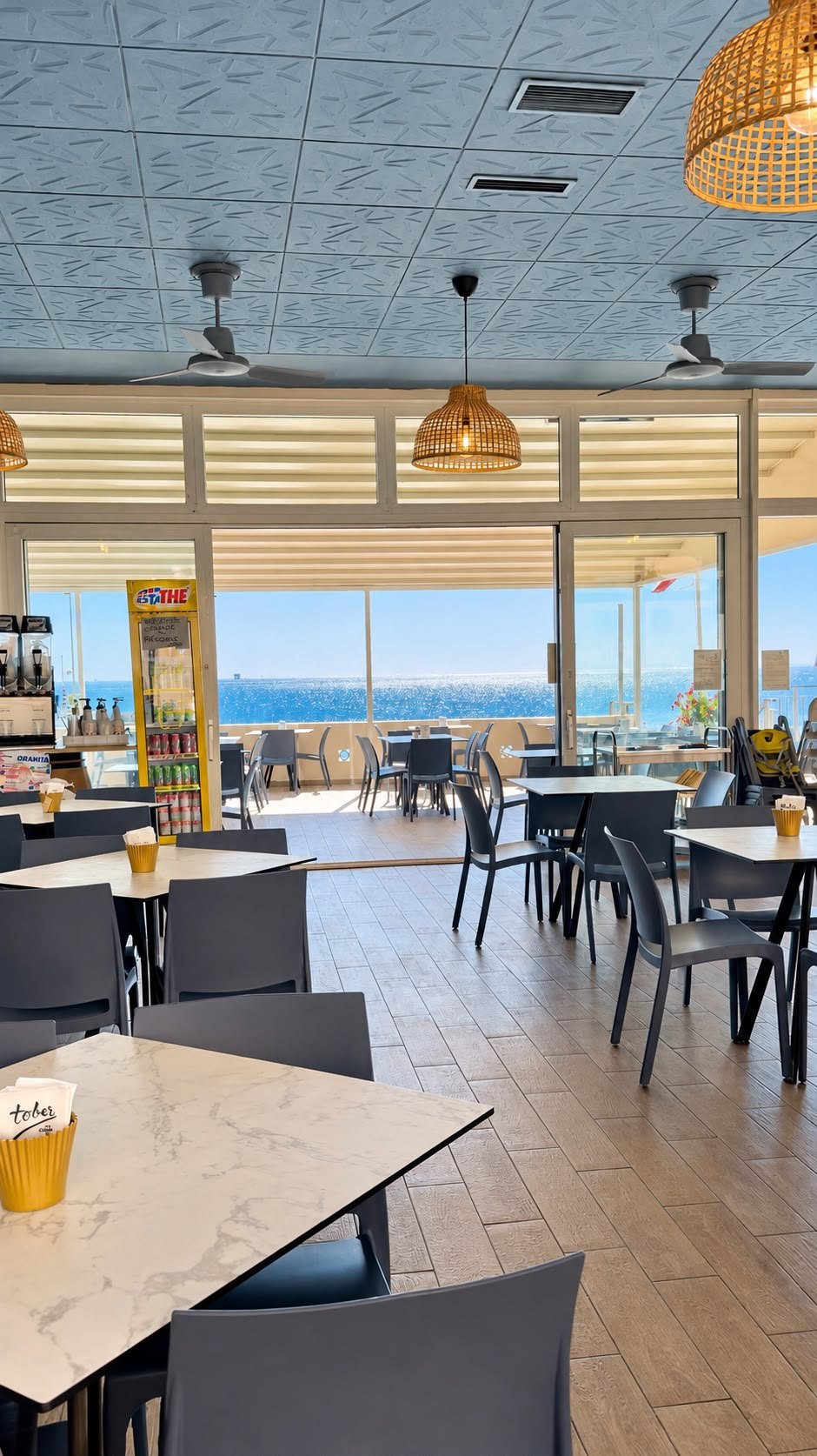 La sala Ai Medi con i tavoli e la vista sul mare dalla terrazza
